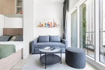 a small living room with a couch and a table at Exclusive Studio by Burj Khalifa and Dubai Mall, High Floor in Dubai