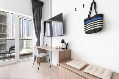 a room with a desk and a table with a chair at Exclusive Studio by Burj Khalifa and Dubai Mall, High Floor in Dubai