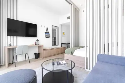 a living room with a couch and a tv at Exclusive Studio by Burj Khalifa and Dubai Mall, High Floor in Dubai