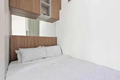 a bedroom with a bed with a wooden headboard at Cozy Studio By Burj Khalifa and Dubai Mall in Dubai