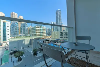 a balcony with a table and a view of a city at Stunning Apt with Balcony & Marina View in Dubai