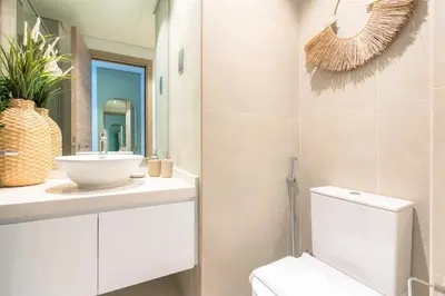 a bathroom with a toilet and a sink and a mirror at Stunning Apt with Balcony & Marina View in Dubai