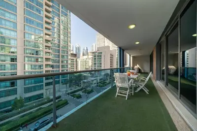 a balcony with a table and chairs in a building at StoneTree - Spacious 2BR in Great Location in Dubai