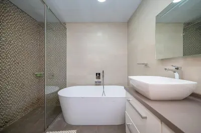 a bathroom with a large white tub and a sink at StoneTree - Spacious 2BR in Great Location in Dubai