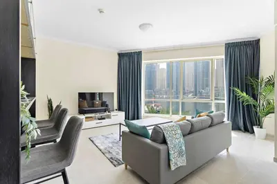 a living room with a couch and a large window at Breathtaking Marina View - Spacious Apartment in Dubai