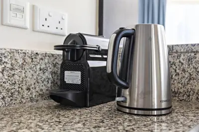 a coffee maker sitting on a counter in a kitchen at Breathtaking Marina View - Spacious Apartment in Dubai