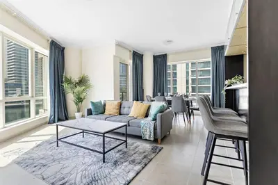 a living room with a couch and a table at Breathtaking Marina View - Spacious Apartment in Dubai