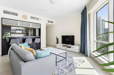 a living room with a couch and a tv at Breathtaking Marina View - Spacious Apartment in Dubai