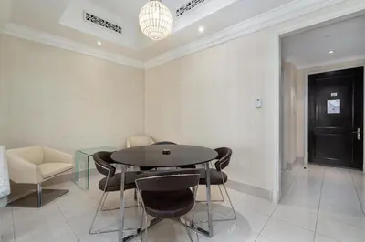 a dining room with a table and chairs at Lux BnB I Souk Al Bahar I Burj Khalifa Views in Dubai
