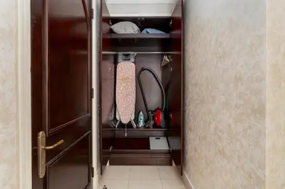 a closet with a door with ties in it at Lux BnB I Souk Al Bahar I Burj Khalifa Views in Dubai