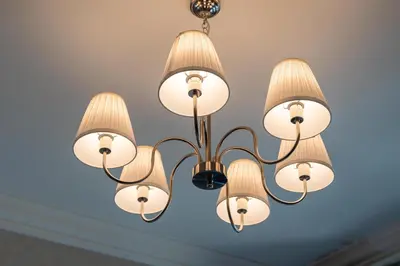 a chandelier with white lights on a ceiling at Lux BnB I Souk Al Bahar I Burj Khalifa Views in Dubai