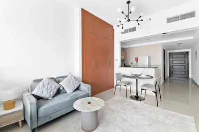 a living room with a couch and a table at StoneTree - Best Deal - Elegant Studio in Dubai