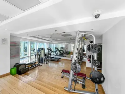 a gym with several treadmills and machines in a room at StoneTree - Best Deal - Elegant Studio in Dubai