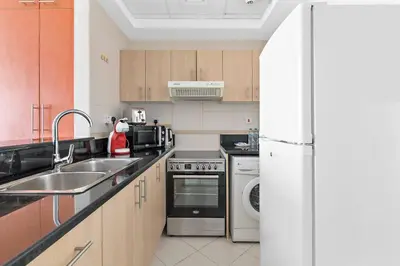 a kitchen with a sink and a dishwasher at StoneTree - Best Deal - Elegant Studio in Dubai
