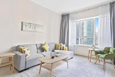 a living room with a couch and a table at StoneTree - Sit Back, Relax and Your New View Awaits in Dubai