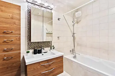 a bathroom with a sink and a tub and a mirror at StoneTree - Sit Back, Relax and Your New View Awaits in Dubai
