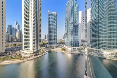 a view of a city with tall buildings and a river at StoneTree - Sit Back, Relax and Your New View Awaits in Dubai