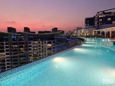 a large swimming pool on top of a building at SEVEN PALM by Design Studio 2BR in Dubai