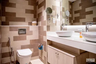 a bathroom with two sinks and a toilet at SEVEN PALM by Design Studio 2BR in Dubai