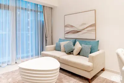 a living room with a couch and a table at SEVEN PALM by Design Studio 2BR in Dubai