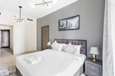 a bedroom with a large white bed in a room at StoneTree - Elegant 1BR in Famous Location in Dubai