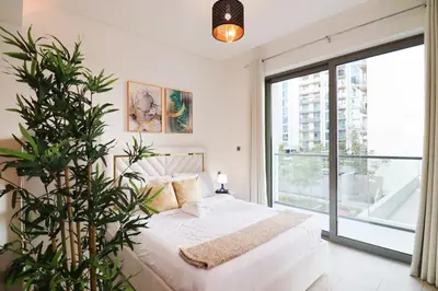 a bedroom with a white bed and a large window at Celestial Ambiance Studio in Dubai