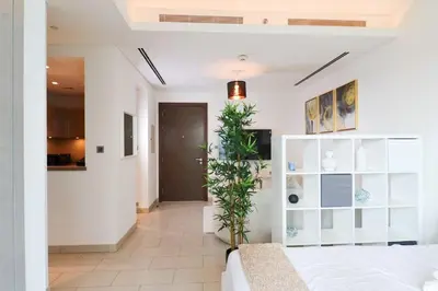 a bedroom with a bed and a plant at Celestial Ambiance Studio in Dubai
