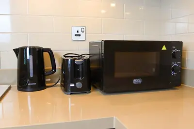 a microwave sitting on a counter next to a coffee maker at Celestial Ambiance Studio in Dubai
