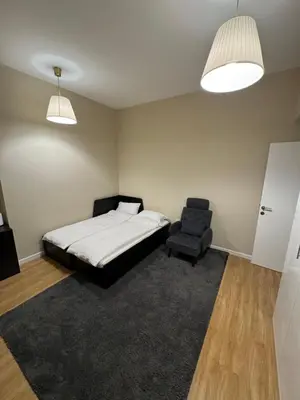 a bedroom with a bed and a chair and two lights at Upscale 3br in JBR next to Ritz-Carlton in Dubai