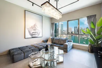 a living room with a couch and a large window at Marina Panorama Paradise in Dubai