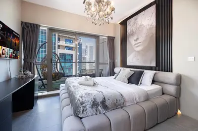 a bedroom with a large bed and a large window at Marina Panorama Paradise in Dubai