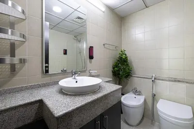 a bathroom with a sink and a toilet and a mirror at Marina Panorama Paradise in Dubai