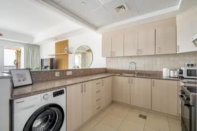 a kitchen with a washer and dryer at GuestReady - Exquisite stay near Dubai Canal in Dubai