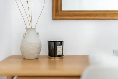 a vase and a candle sitting on a table at GuestReady - Exquisite stay near Dubai Canal in Dubai