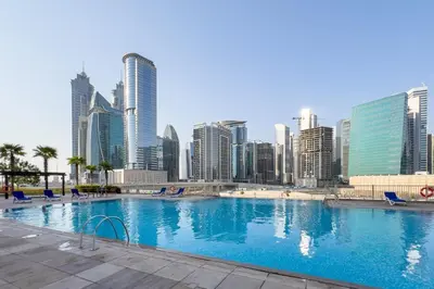 a large swimming pool in a city with tall buildings at GuestReady - Exquisite stay near Dubai Canal in Dubai