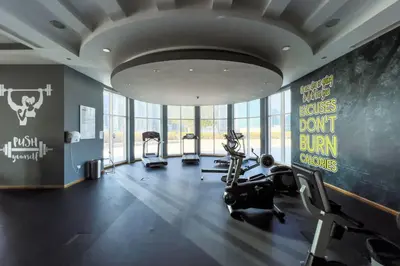 a gym with treadmills and cardio equipment in a building at GuestReady - Exquisite stay near Dubai Canal in Dubai