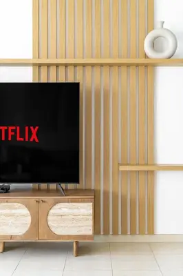 a flat screen tv sitting on top of a wooden entertainment center at GuestReady - Exquisite stay near Dubai Canal in Dubai