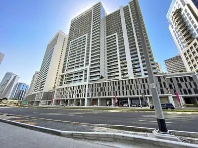 a large building on a city street with tall buildings at StoneTree - Modern 1BR Apartment in Vera Residence in Dubai