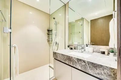 a bathroom with a glass shower and a sink at Stunning 2 bedroom apartment near Burj Khalifa in Dubai