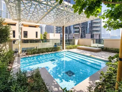 an outdoor swimming pool with a pergola on a building at Stunning 2 bedroom apartment near Burj Khalifa in Dubai