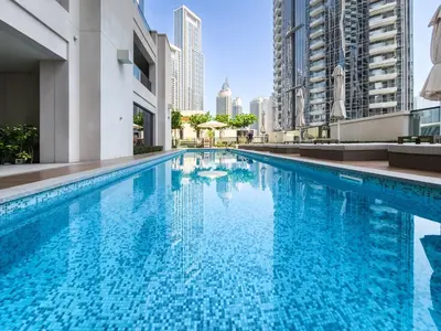 a swimming pool in a city with tall buildings at Stunning 2 bedroom apartment near Burj Khalifa in Dubai