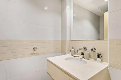 a white bathroom with a sink and a tub at StoneTree - Stylish fully-furnished 1 BR in Dubai