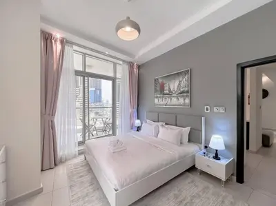 a bedroom with a white bed and a large window at StoneTree - Amazing View - Modern 1BR in Dubai