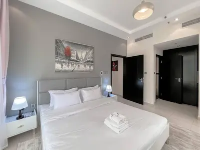 a bedroom with a large white bed with white pillows at StoneTree - Amazing View - Modern 1BR in Dubai