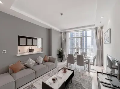 a living room with a couch and a dining room at StoneTree - Amazing View - Modern 1BR in Dubai