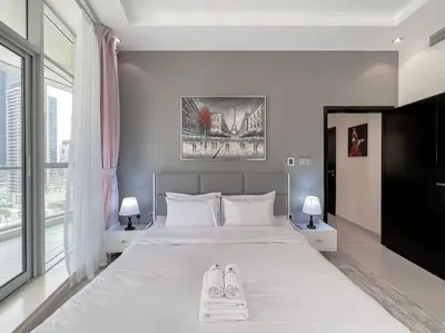a bedroom with a bed with two pairs of shoes on it at StoneTree - Amazing View - Modern 1BR in Dubai