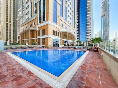 a large swimming pool in the middle of a building at StoneTree - High Floor Furnished 1 BR in Dubai