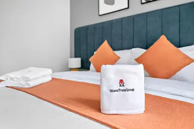 a white towel sitting on top of a bed at StoneTree - Furnished 1BR with Stunning View in Dubai