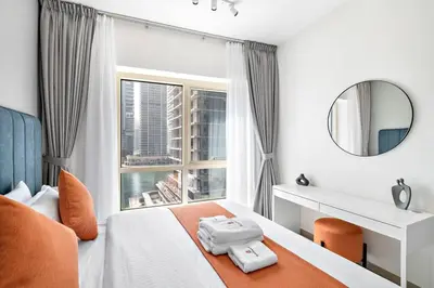 a hotel room with a bed and a window at StoneTree - Furnished 1BR with Stunning View in Dubai