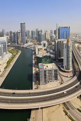 an aerial view of a city with a river and buildings at Amazing 4-bedroom Apartment in Dubai